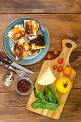 Wall Mural - Fried pita bread filled with cheese, tomato and greens