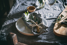 Table Setting With White Plate, Linen Napkin, Olive Brunch Trendy Rustic Table Setting