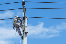 Electricians Repairing,electricians Repairing Wire On Electric Power Pole, Power Linesman Climb The Pole.It's A Dangerous Job.