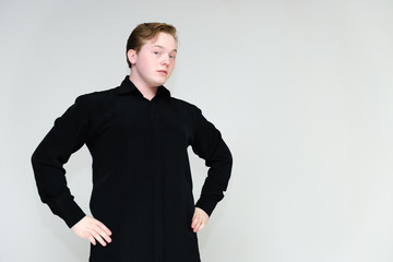 Portrait to the waist on a white background of a handsome young man in a black shirt. stands directly in front of the camera in different poses, talking, showing emotions, showing hands.