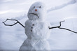 Sad snowman frowning in Sierra winter snow - California
