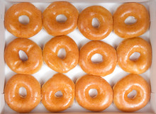 Top View Flat Lay Of Plain Glazed Donuts In A White Box Isolated. One Dozen Donuts. The Original Glazed Donut Has Remained Peoples Favorite Throughout History.