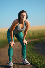 Wall Mural - Fit sporty woman rest after jogging workout. Motivation, endurance, sports, fitness, health care