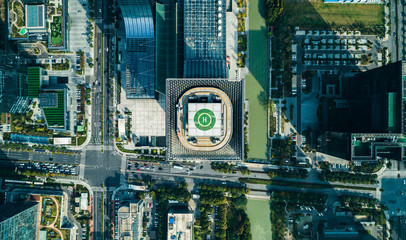 Aerial drone view of helipad on the roof of a skyscraper iin downtown with cityscape view on sunny day