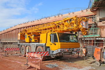 Wall Mural - Mobile crane by a bridge under construction