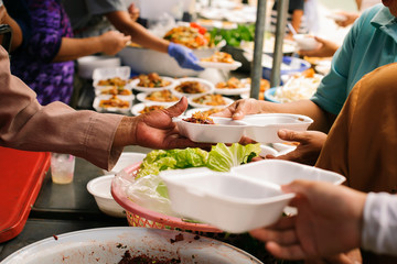 Hands of beggars accepting food from the hands of volunteers who come to help free food breaks : Social Problems of Poverty Helped by Feeding