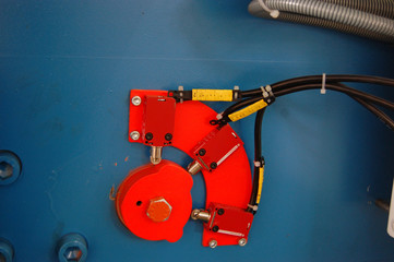 a fragment of an industrial machine with a cam mechanism and limit switches