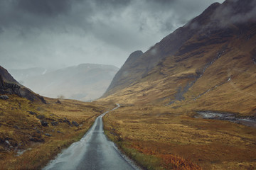 Beautiful scenic road in Glen Etive, Glen Coe Scotland. Skyfall landscape in rainy foggy weather.