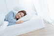 beautiful asian woman blue sweater lay done on white bed casual lifestyle morning time weekend concept