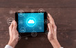 © ra2 studio - Hand touching tablet with cloud computing and online storage concept