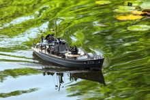 A Miniature Military Speedboat On A Pond