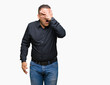 © Krakenimages.com - Handsome middle age arab business man over isolated background peeking in shock covering face and eyes with hand, looking through fingers with embarrassed expression.