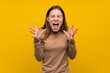 Young woman over colorful background unhappy and frustrated with something