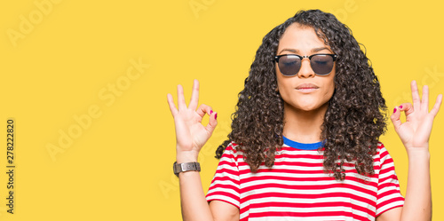 Young Beautiful Woman With Curly Hair Wearing Sunglasses Relax And