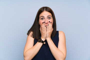 Wall Mural - Young woman over isolated blue wall with surprise facial expression