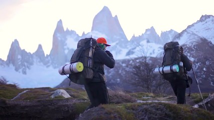 guys hiking on el chalten trail in patagonia with fitz roy behind