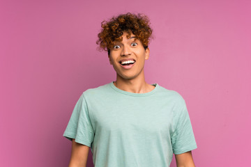 Wall Mural - Young african american man over isolated purple wall with surprise facial expression