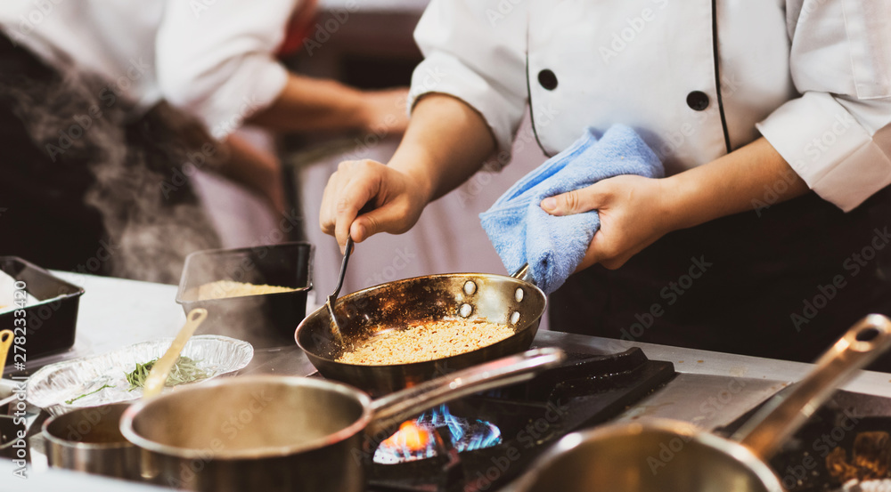 Chef cooking food in the kitchen, Chef preparing food Stock Photo ...