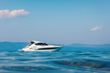 Motor boat floating on clear turquoise water