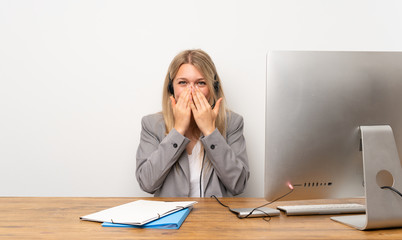 Wall Mural - Young woman working with headset with surprise facial expression