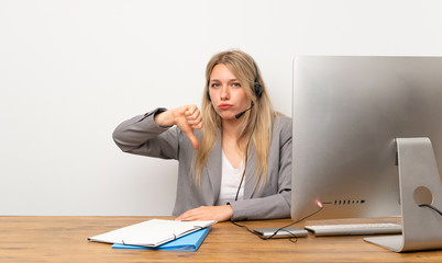 Wall Mural - Young woman working with headset showing thumb down sign