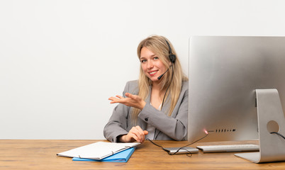 Wall Mural - Young woman working with headset extending hands to the side for inviting to come