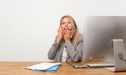 Wall Mural - Young woman working with headset with surprise facial expression