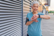 © Dragana Gordic - Checking the pulse. Athletic mature woman monitoring her running performance on smartwatch. How long was that? Senior woman setting up the fitness smart watch for running and checking watch device