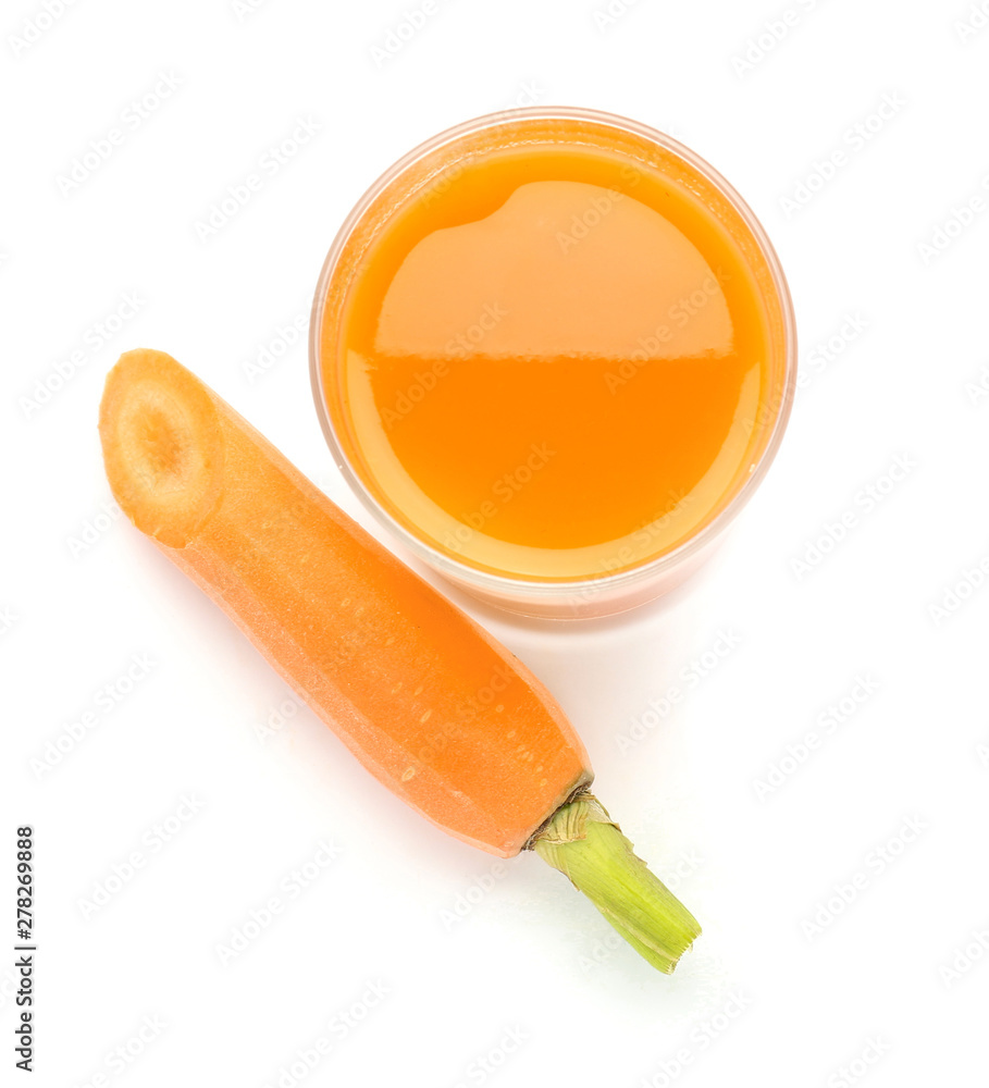 Glass of fresh carrot juice on white background