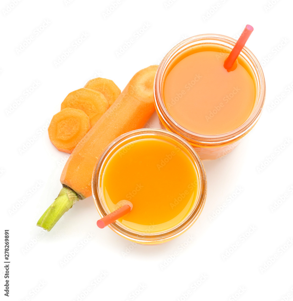 Glasses of fresh carrot juice on white background