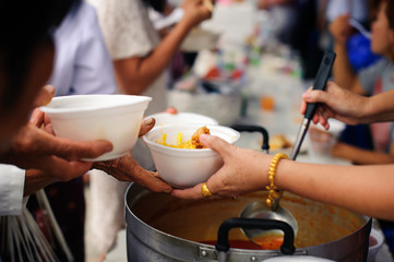 The hands of beggars receive donated food : The concept of food shortages