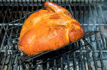 Wall Mural - Barbecue with chicken grilling on a summer barbecue top view