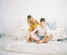 Happy Couple In White Living Room