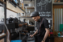 Male Waiter Preparing A Coffee With An Espresso Machine