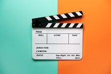 Movie Clapper On Color Table Background; Film, Cinema And Video Photography Concept