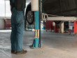 © Milles Studio/Stocksy - Crop technician lifting car up with equipment