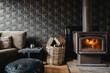 © Jodie Johnson/Stocksy - Cosy interior of a log fire and dark wallpaper