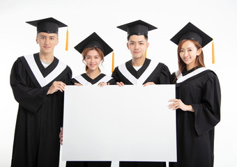 young Group of graduate students presenting empty banner..