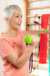 © Microgen - Senior Woman Exercising With Dumbbells