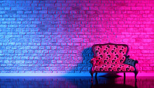 Retro Sofa On The Background Of An Old Brick Wall In The Enon Light, 3d Illustration