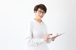 © satura_ - Beautiful woman 50 years old with short hair holding tablet on white background