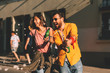 © djile - Young couple dancing on the street and holding two bottles of beer