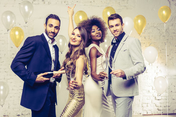 Wall Mural - Group of women and men celebrating with champagne