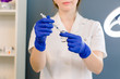 © sofiko14 - Hair beauty, mesotherapy: a beautician trichologist doctor preparing medication for a needle mesotherapy treatment on a woman's face or hair