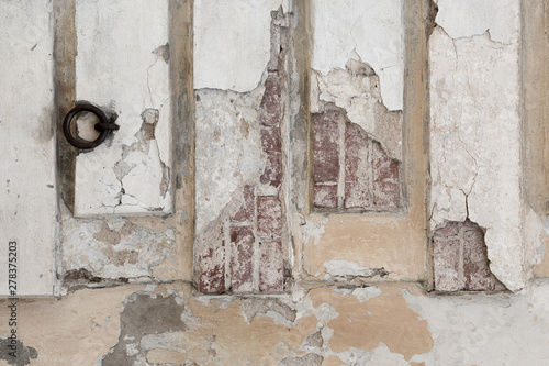 old shabby damaged plaster on the walls of houses close-up © Irina