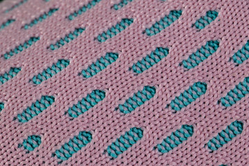 A fragment of blue and pink fabric sneaker. The texture of the material of sports shoes