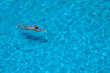 © Aleksej - Woman swims in the pool. Summer and vacation concept