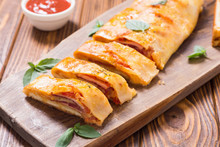 Pizza Roll Stromboli With Cheese Salami Olives And Tomatoes