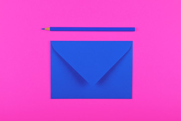 Wall Mural - Closed blue paper envelope over magenta