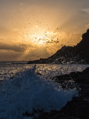 sunrise wave breaks on the rock, Pantelleria, Italy